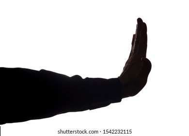 Old man's hand shows a symbol of a stop, denial, disagreement - silhouette