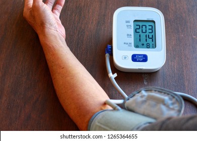 Old Man's Health Check Blood Pressure And Heart Rate At Home With Digital Pressure Very High Blood Pressure Test Results.Risk For Cardiology.Need Some Medicine.Health And Medical Concept.