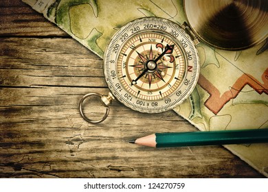 Old Map And Compass On A Wooden Table