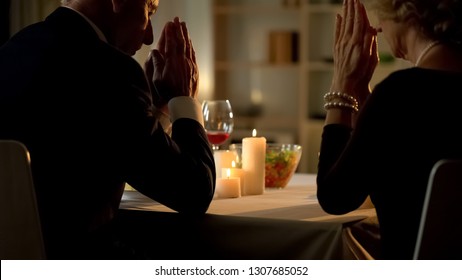 Old Married Couple Praying Before Meal, Sitting At Table, Thanksgiving Dinner