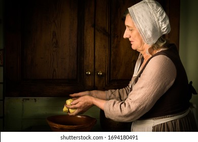 Old Master Style Renaissance Portrait Of A Woman Preparing Food In An Antique Kitchen