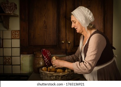 Old Master Style Renaissance Portrait Of A Woman Preparing Food In An Antique Kitchen