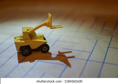 An Old Match Box Toy Car Running On A Wooden Labyrinth Pattern, Designed With A Blue Pen