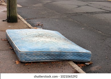 Old Mattress Sitting Outside On Curb
