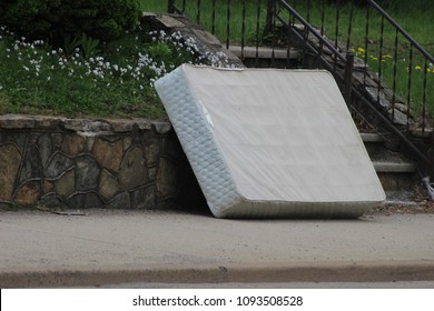 Old Mattress Sitting Outside On Curb
