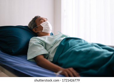 Old Mature Patient  In Hospital Ward On Hospital Bed Wear Protection Mask For Prevent The Spread Of The Virus