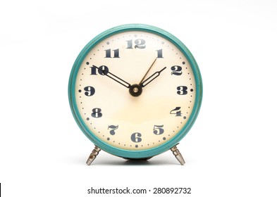 Old mechanical alarm clock on white background
