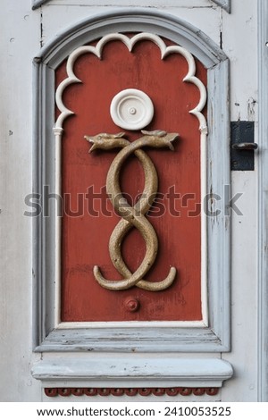 Old medicine symbol of old pharmacy. Retro emblem of medicine - two snakes, caduceus, signboard on a wooden door. 