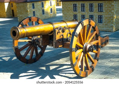 Old Medieval Artillery Canon Before A Brick Wall