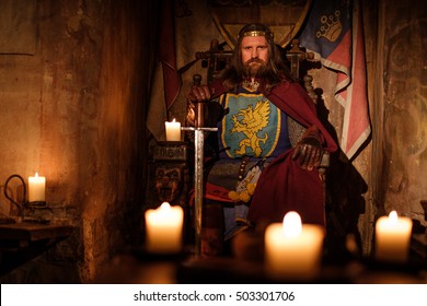 Old Medieval King On The Throne In Ancient Castle Interior.