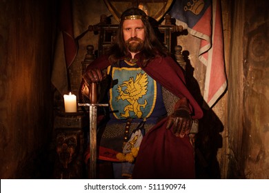 Old Medieval King On The Throne In Ancient Castle Interior.