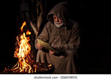 Old Medieval Man Reading Message By The Fire 