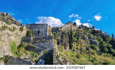 Old medieval ruin of castle on Kotor city wall in Montenegro, Balkan Peninsula, Europe. Lovcen and Orjen mountains, Dinaric alps. Hiking trail to San Giovanni fortress. Historical landmark. Tourism