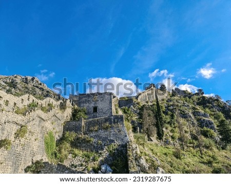 Old medieval ruin of castle on Kotor city wall in Montenegro, Balkan Peninsula, Europe. Lovcen and Orjen mountains, Dinaric alps. Hiking trail to San Giovanni fortress. Historical landmark. Tourism