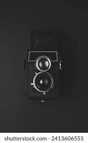 An old medium format camera on a black background
