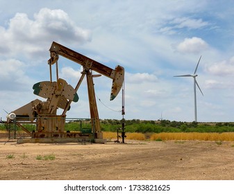 The Old Meets New As A Wind Turbine Flanks An Oilfield Pump Jack Or Pumping Unit.