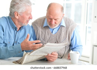 Old Men Reading A Newspaper