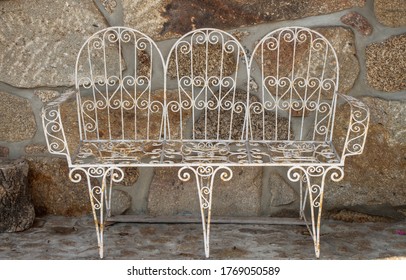 Old Metal Bench In Stone Wall