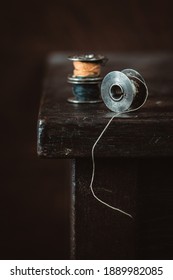 Old Metal Bobbin Spools On Wooden Table. Selective Focus