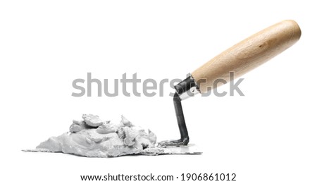 Old metal bricklaying trowel with wet cement, mortar isolated on white background