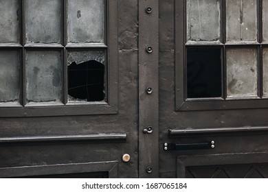 Old Metal Brown Entrance Door With Broken Glass. The Concept Of Burglary, Violation Of Private Property Rights. Closeup.