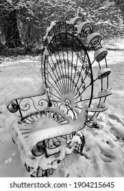 Old Metal Chair With Swirls Of Snow