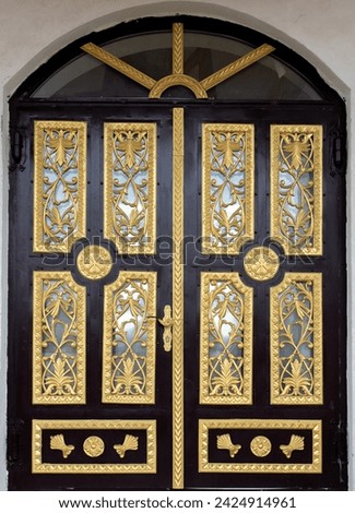 An old metal door with golden ornaments at the Toplita monasteries - Romania