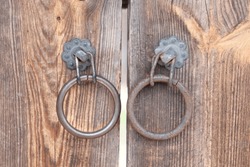 Old, Metal, Door Handle Knocker In The Form Of A Ring On Wooden Background. New And Rusty.