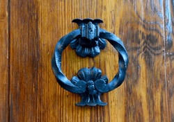 Old Metal Door Handle Knocker In The Form Of A Ring On Ancient Wooden Background.Selective Focus.