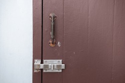 Old Metal Door Handle With Door Latch On Wooden Door
