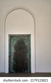 Old Metal Door Inwhite Wall, Background Texture. Classic Architecture Details