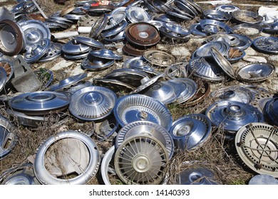 Old Metal Hubcaps Strewn Across The Ground.