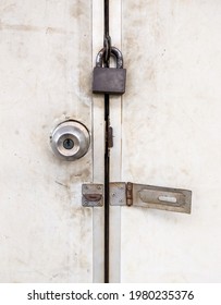 The Old Metal Knob Door And Brass Master Key On The PVC Door Of The Electrical Control Room In The Local Train Station, Front View For The Copy Space.