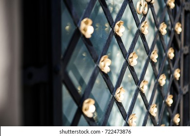 Old Metal Lattice Window In The Wall