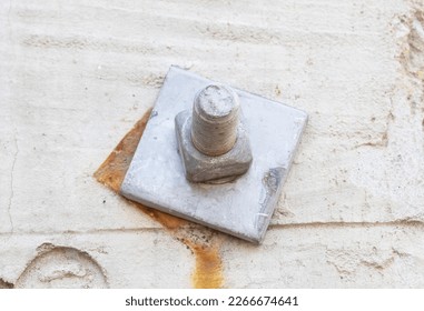 Old Metal male square nut screw nail heads attached concrete cement plinth  To attach structure wall to be strong for wall house various industrial applications  Bolts   screws 