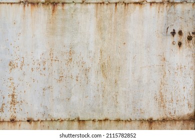 Old metal surface in white. Connections of sheets of iron are visible. There are holes, pockets of corrosion and streaks of rust. Background.Texture.  - Powered by Shutterstock