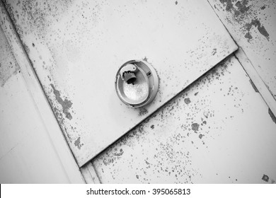 Old Metallic Door With A Broken Light Fixture