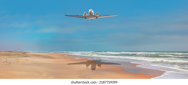 Old metallic propeller airplane in the sky, sunset clouds in the background - Namib desert with Atlantic ocean meets near Skeleton coast - 
Namibia, South Africa
