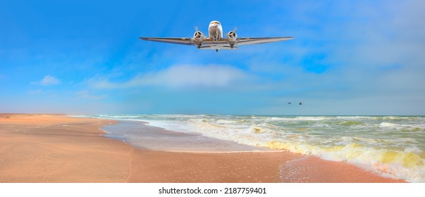 Old metallic propeller airplane in the sky, sunset clouds in the background - Namib desert with Atlantic ocean meets near Skeleton coast - 
Namibia, South Africa