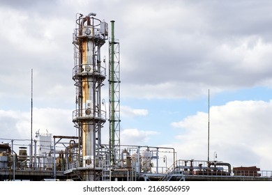 Old Methanol Distillation Rectification Refinery Column Towers Under Cloudy Sky With Lightning Rod For Lightning Protection At Petrochemical Plant Enterprise. Industrial Background With Copy Space.