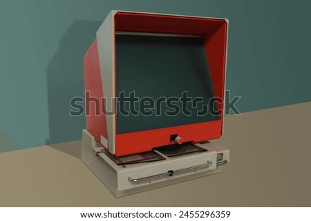 Old microfiche reader is a device composed of a large green screen surrounded by an orange trapezoidal casing. The white metal base contains the microfiche reading system, 1975.