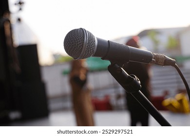 The old microphone carries a nostalgic charm with its worn metal casing and vintage mesh. Its faded finish tells stories of past performances and voices long heard. - Powered by Shutterstock