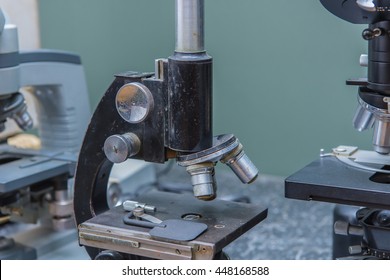 old microscope for test sample making research in clinical laboratory.