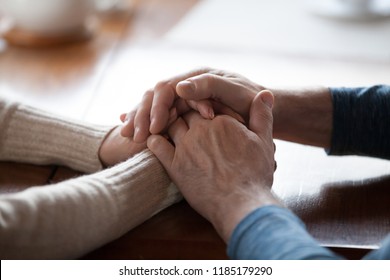 Old middle aged people holding hands close up view, senior retired family couple express care as psychological support concept, trust in happy marriage, empathy hope understanding love for many years