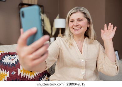 Old Middle Aged Woman Having Video Chat Using Smartphone Chatting To Child On Mobile Phone Screen Smiling Enjoying Conversation Sharing Lifestyle With Family.