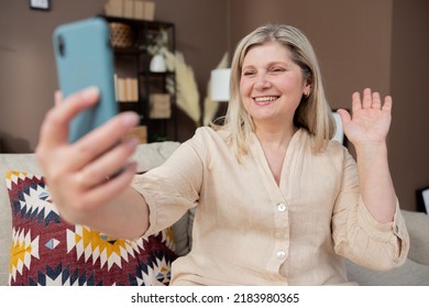 Old Middle Aged Woman Having Video Chat Using Smartphone Chatting To Child On Mobile Phone Screen Smiling Enjoying Conversation Sharing Lifestyle With Family.