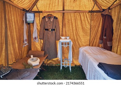 An Old Military Field Hospital With Retro Tents And Vintage Medical Beds From The First World War. Mobile Clinic For The Treatment Of Soldiers Of The Early Twentieth Century