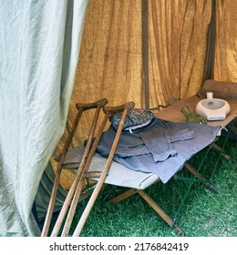 An Old Military Field Hospital With Retro Tents And Vintage Medical Beds From The First World War. Mobile Clinic For The Treatment Of Soldiers Of The Early Twentieth Century