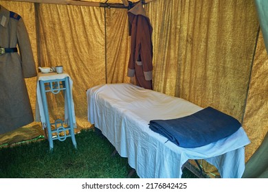 An Old Military Field Hospital With Retro Tents And Vintage Medical Beds From The First World War. Mobile Clinic For The Treatment Of Soldiers Of The Early Twentieth Century