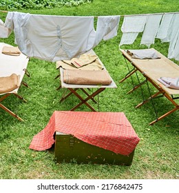 An Old Military Field Hospital With Retro Tents And Vintage Medical Beds From The First World War. Mobile Clinic For The Treatment Of Soldiers Of The Early Twentieth Century